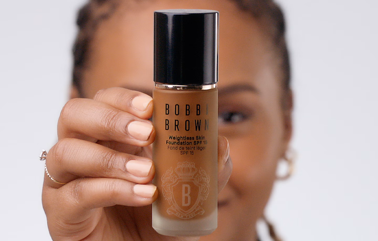 Bottles of Bobbi Brown Skin Long-Wear Weightless Foundation SPF 15 in a range of shades, showcasing its liquid texture.